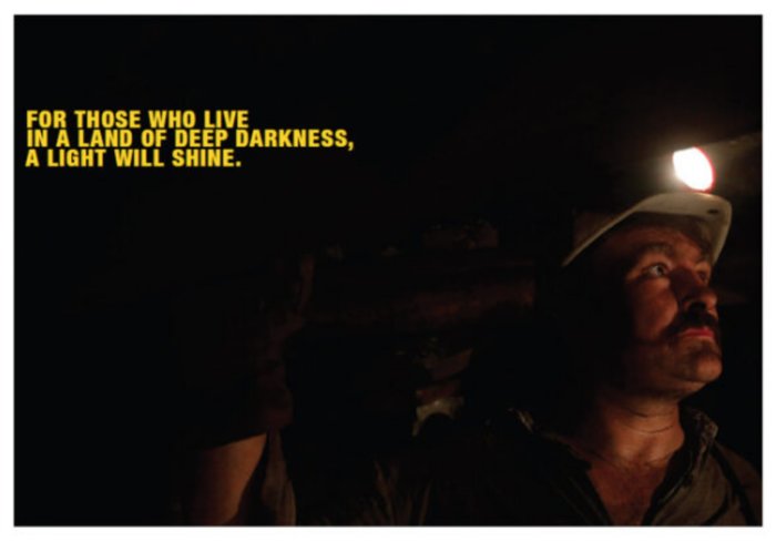 A miner in the last deep-cast coal mine in Hungary set to close. Over the top left corner of the photo are the words of Isaiah9:2, 'For those who live in a land of deep darkness, a light will shine.' Source: REUTERS/Laszlo Balogh